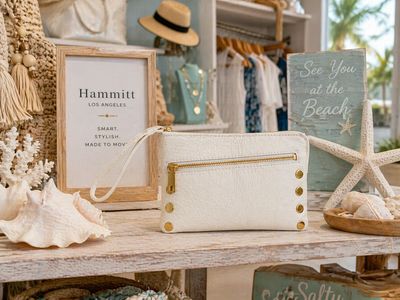 Hammitt Nash Sml wristlet in calla lily white with gold hardware displayed in a beach-themed boutique with coastal decor