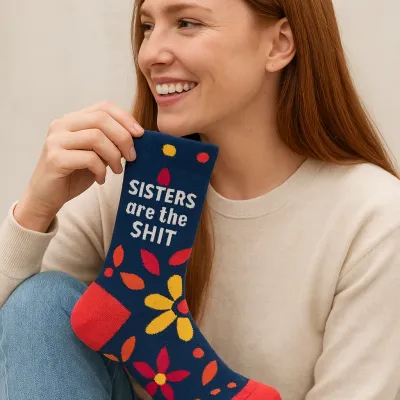 Blue Q women's crew socks with humorous text displayed on a person wearing casual clothing