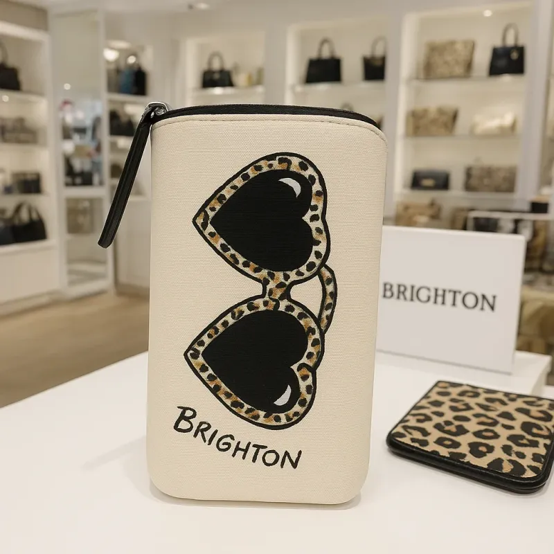 Brighton Wild Cat Leopard Heart sunglass case in leopard print with heart detail and extra pocket, displayed in a lifestyle setting