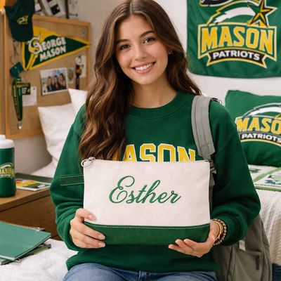 Personalized canvas makeup bag with custom embroidered name in green shown in lifestyle dorm setting