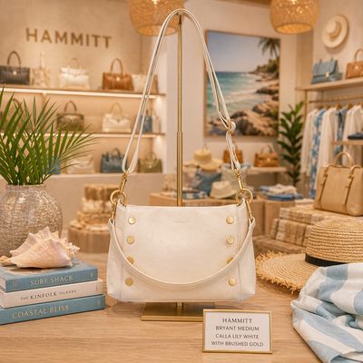 Hammitt Bryant Medium crossbody in calla lily white leather with brushed gold hardware displayed in a bright, beach-inspired 