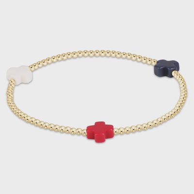 ENEWTON Signature Cross 2mm gold-filled bracelet in firecracker beads on a neutral background