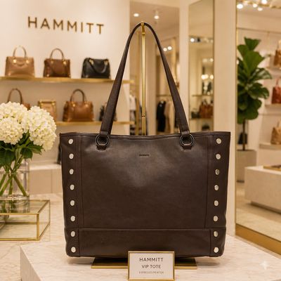 Hammitt VIP tote in espresso leather with pewter studs displayed on stand in luxury boutique store