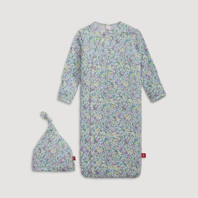 Newborn wearing Lavinia modal magnetic gown and matching hat in soft neutral tones during daytime.