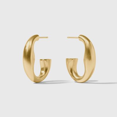 Julie Vos Laguna hoop earrings in 24K gold plate with post back closure, displayed in a lifestyle setting