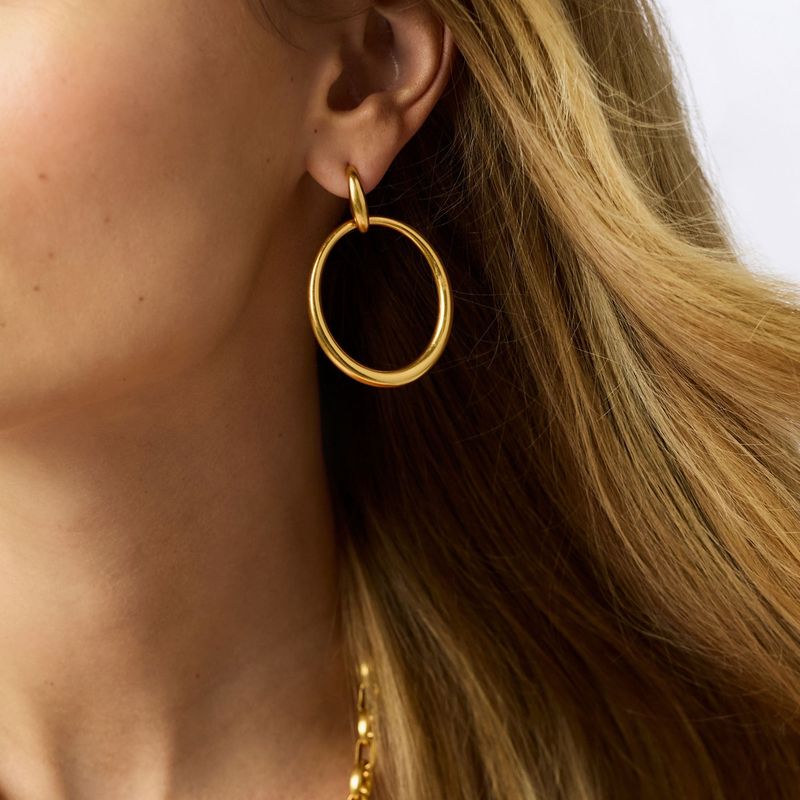 Julie Vos Laguna doorknocker earrings in 24K gold plate worn as a lifestyle detail shot