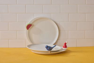 Nora Fleming Celebration Circle stoneware dinner plate in 11.5-inch size displayed in a table setting with place setting context.