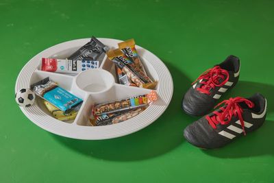 Nora Fleming Kickin' It soccer mini hand-painted tabletop décor displayed in a lifestyle setting