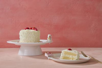 Nora Fleming Slice of Forever wedding cake mini tabletop accent displayed in a styled table setting with decorative elements