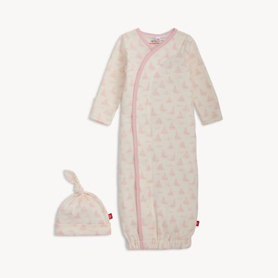 Pink Tiny Tides organic cotton magnetic gown and matching hat set laid flat on white background, showing magnetic closures and soft cotton fabric