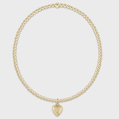 Gold-filled beaded bracelet with 2mm spheres and small love charm attached, photographed against a white background