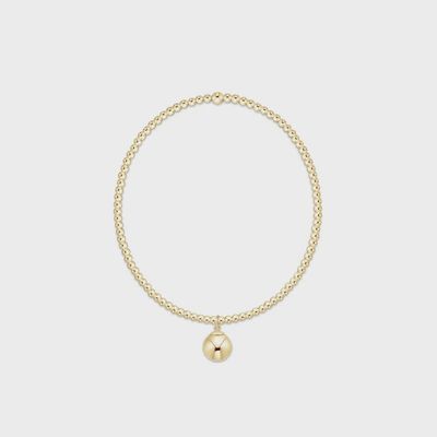 Gold beaded bracelet with 2mm beads and 8mm charm detail on white background