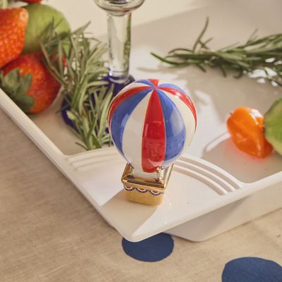 Nora Fleming red, white, and blue patriotic hot air balloon mini figurine displayed in a lifestyle setting