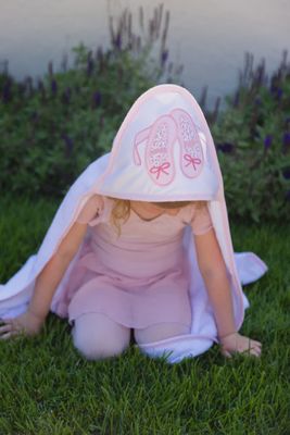 Three Marthas ballet-themed hooded baby towel and washcloth set in a lifestyle bath setting, featuring soft terry cloth construction in 38x38 inches.