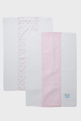 Two pink cloth diaper fabric burp cloths from 3 Marthas displayed in a home setting with soft natural lighting