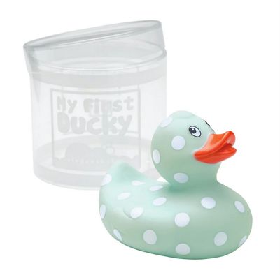 Yellow rubber duckie with white polka dots floating in bathwater during bath time