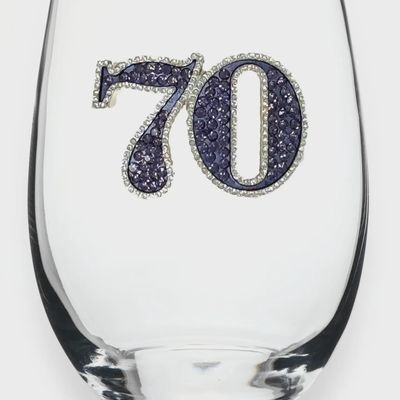 Clear stemless wine glass with etched 70th birthday design on white background