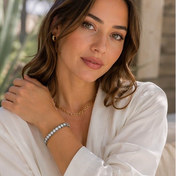 Woman wearing French Kande Swarovski crystal bangle bracelet styled with casual outfit showing elegant sterling silver plated