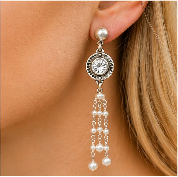 Close-up of French Kande Swarovski Crystal Annecy pearl tassel earrings in sterling silver plating worn on ear