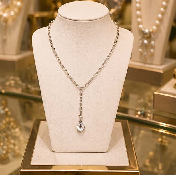 Sterling silver Inaya Necklace by French Kande displayed on luxury jewelry stand with Swarovski crystal pendant in boutique r