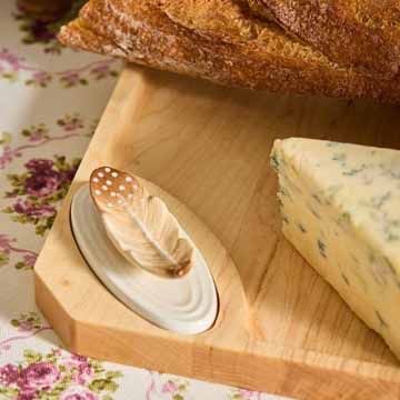Nora Fleming feather mini on charcuterie board with bread and cheese for entertaining and serving presentation