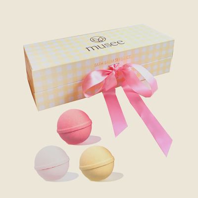 Three gingham-patterned bath balms from Musee displayed against a white background in a studio setting