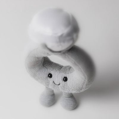 Jellycat Amuseables Diamond Ring plush toy displayed on a soft neutral surface, showing the character's embroidered details and fabric texture.