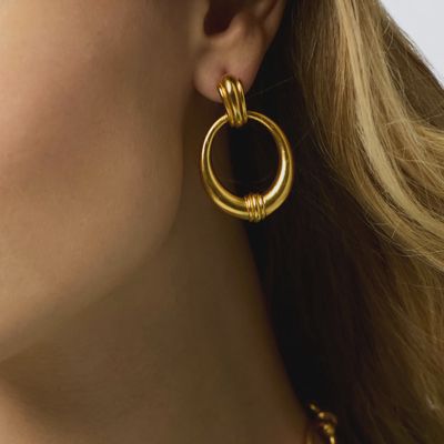 Julie Vos Portofino doorknocker earrings in 24K gold plate, worn as post earrings in a lifestyle setting