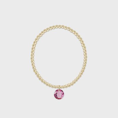 Gold 3mm beaded bracelet with October Reflection charm displayed on white background in studio lighting