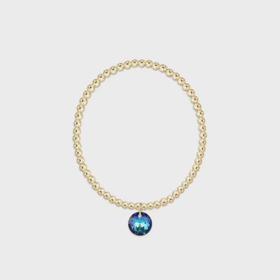 Gold 3mm beaded bracelet with Reflection charm and December birthstone, displayed on neutral background