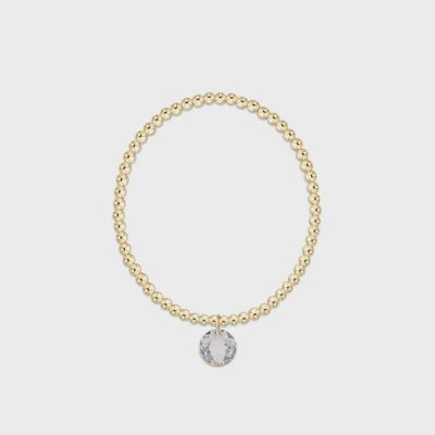 Gold 3mm beaded bracelet with April birthday reflection charm on white background