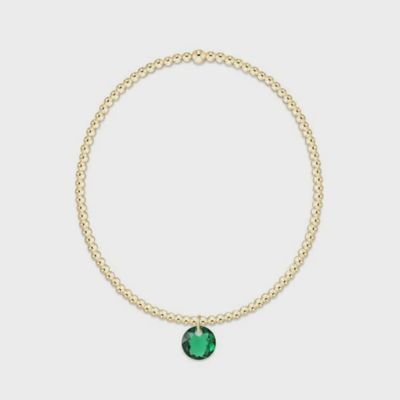 Gold beaded bracelet with small round May Reflection charm, displayed against a clean white background