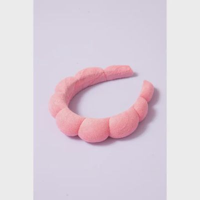 Terry cloth spa headband in soft terry material worn during a face washing routine, designed for beauty and skincare care