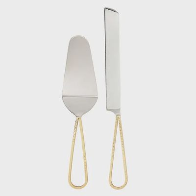 Two-piece cake knife and server set with gold handles displayed on white background, featuring stainless steel blades and matching gold-tone hardware