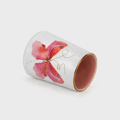 Small pink vase with butterfly design and 'Picked with Love' text, displayed on a white surface in a home setting