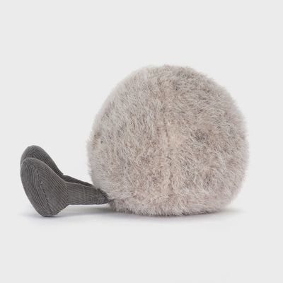 Jellycat Amuseables Pebble soft plush toy in a lifestyle setting, showing the rounded gray fabric toy with embroidered details.
