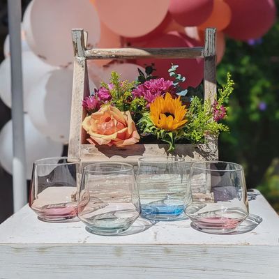Four clear Mezclada stemless glasses arranged on a neutral surface in a home setting