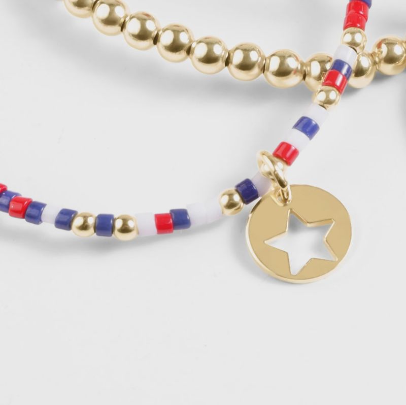 ENEWTON Hope Firecracker bracelet in 14kt gold with star disc charm worn on wrist in lifestyle setting