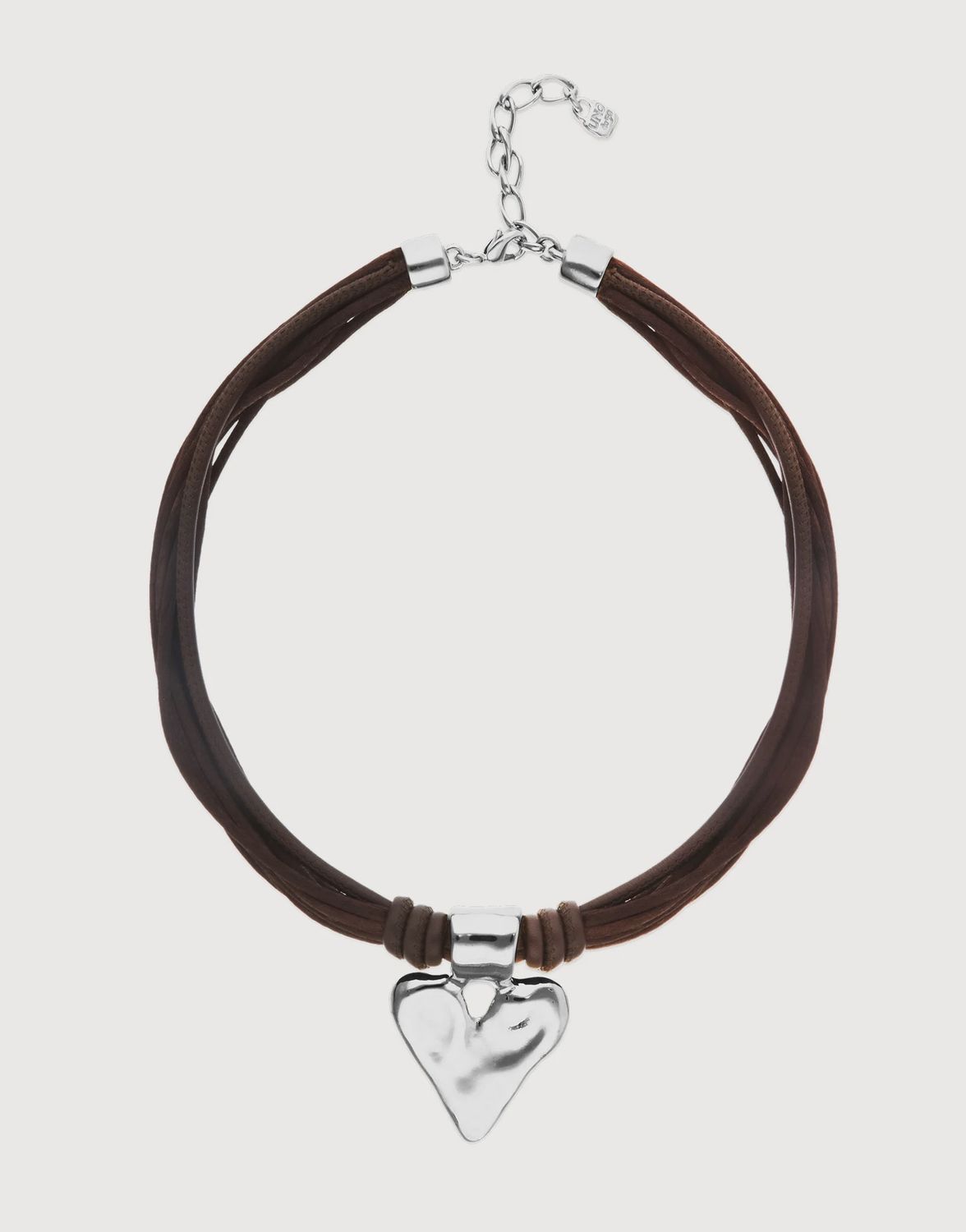 Handmade leather and silk heart necklace from Uno de 50's Beat Collection, displayed on a neutral studio background