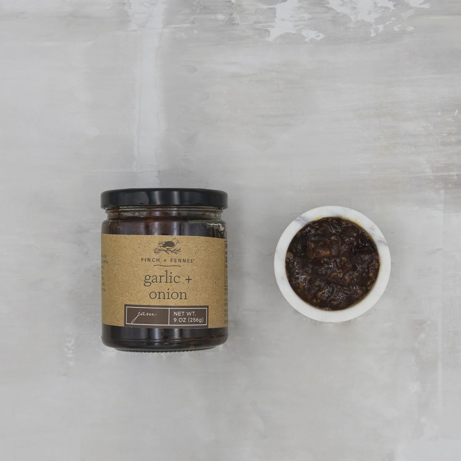 CreativeCo-Op Garlic &amp; Onion Savory Jam in a 9 oz glass jar with label, centered against a neutral background