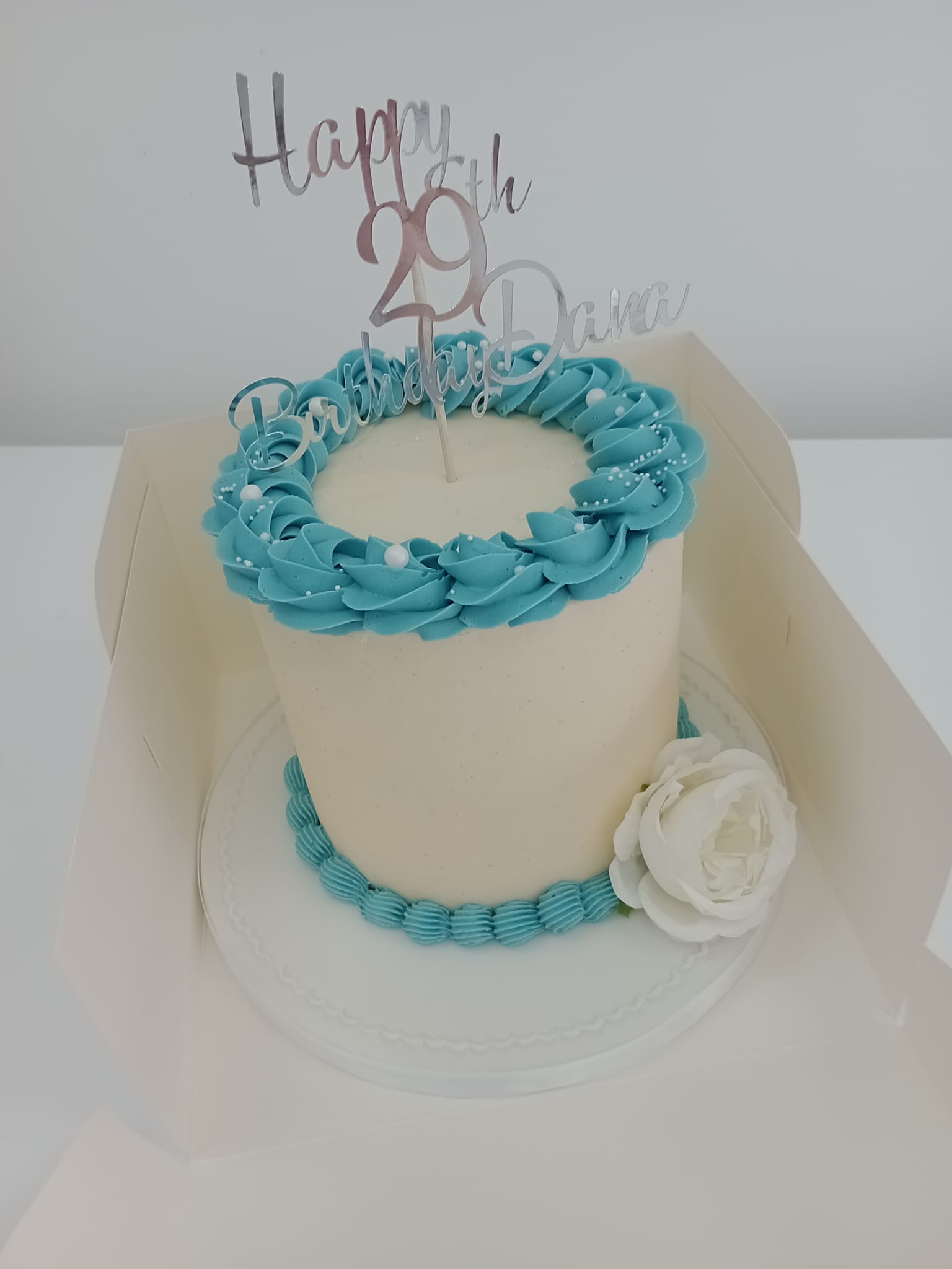 Classic simple buttercream cake with topper