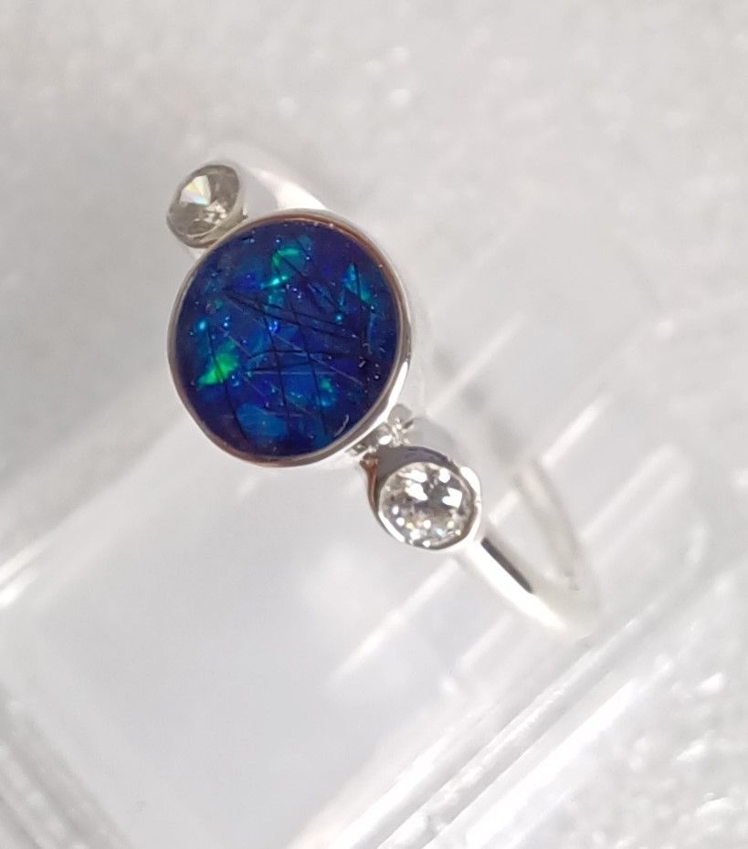 Memorial ring with 6mm bezel for hair or ashes and two CZ stones in rub over settings either side. 