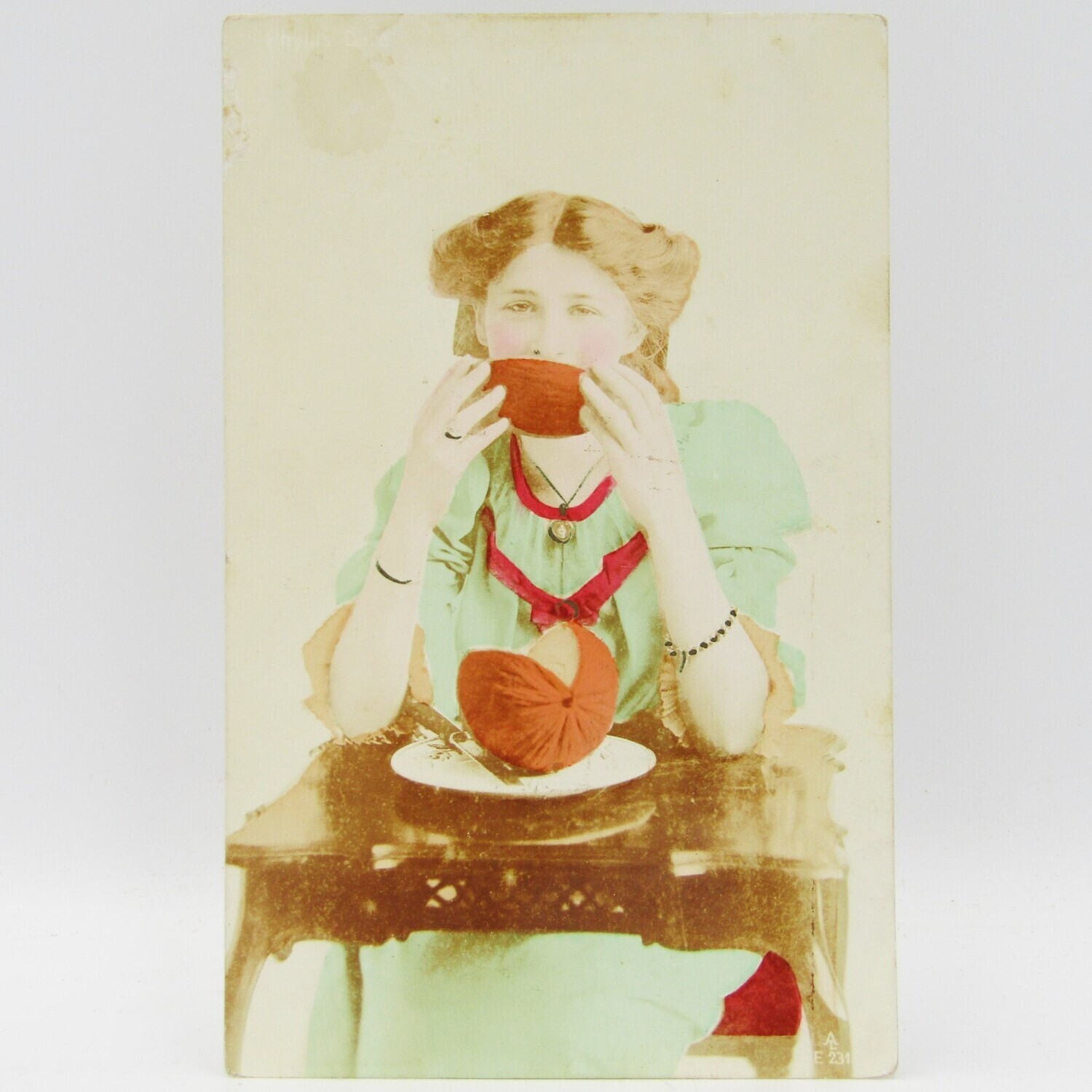 Antique colorized postcards of lady eating a melon