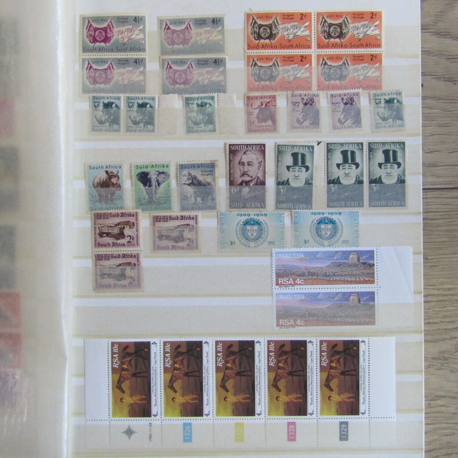 Stamp album with about 850 stamps - most in blocks or control blocks - some early ones