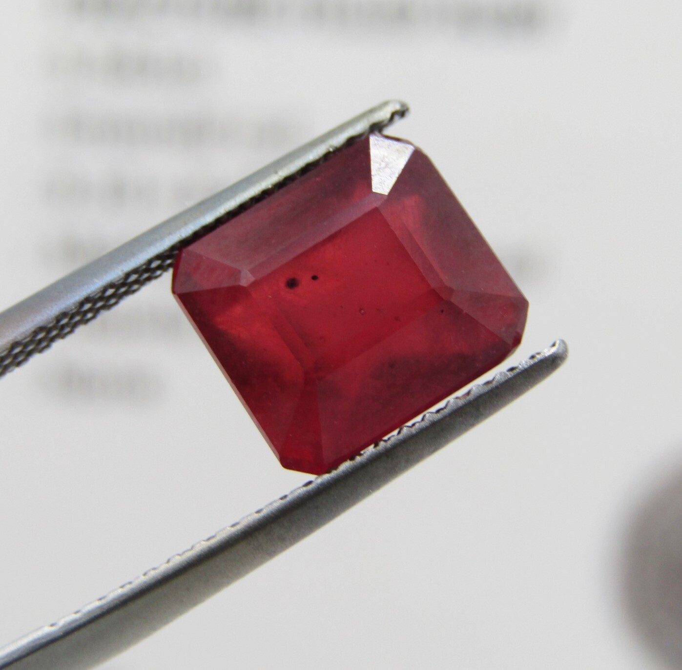 Fracture filled Ruby of 5,5 carat medium dark toned red Emerald cut with Gemlab certificate