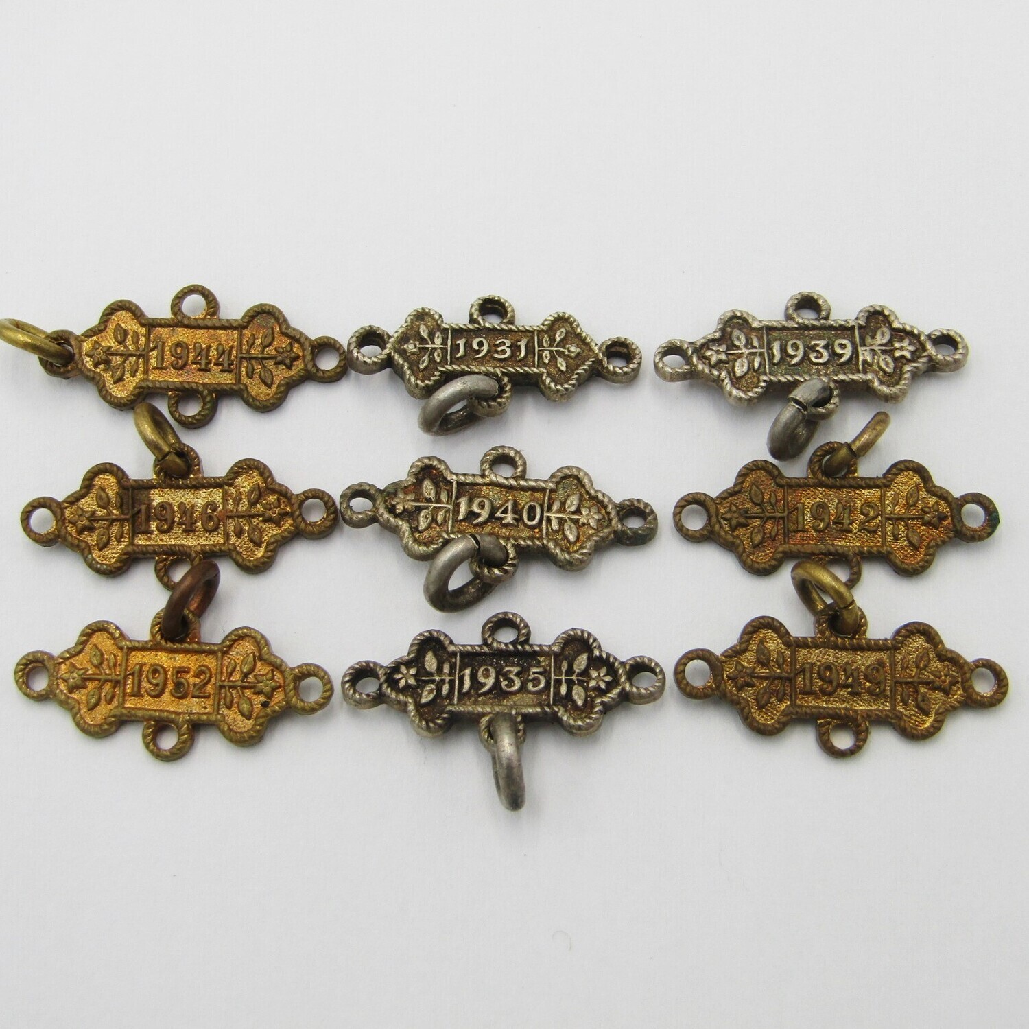 Lot of 9 St John&#39;s Ambulance date labels - some silver