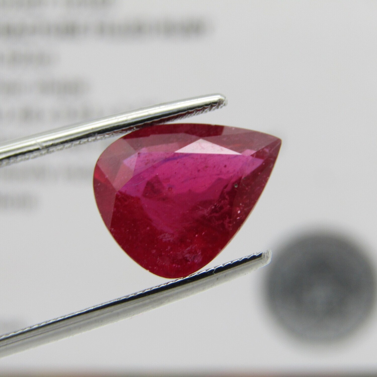 Dark toned slightly purplish red Ruby - fracture filled - 4,92 carat Pear shape with Gemlab certificate