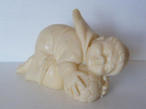 Faux Ivory Monk with soccer ball - marked G.R - weighs 85.2 grams