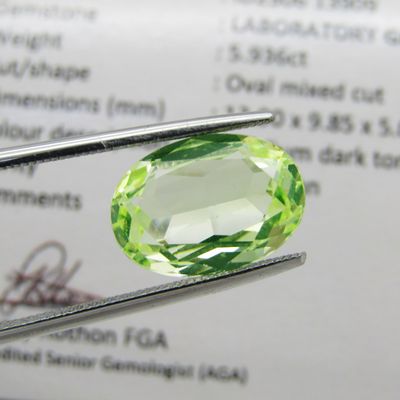 Lab grown Spinel of 5,936 carat - oval mixed cut - Medium dark toned yellowish green - identical to a natural stone at a fraction of the price - with Gemlab certificate