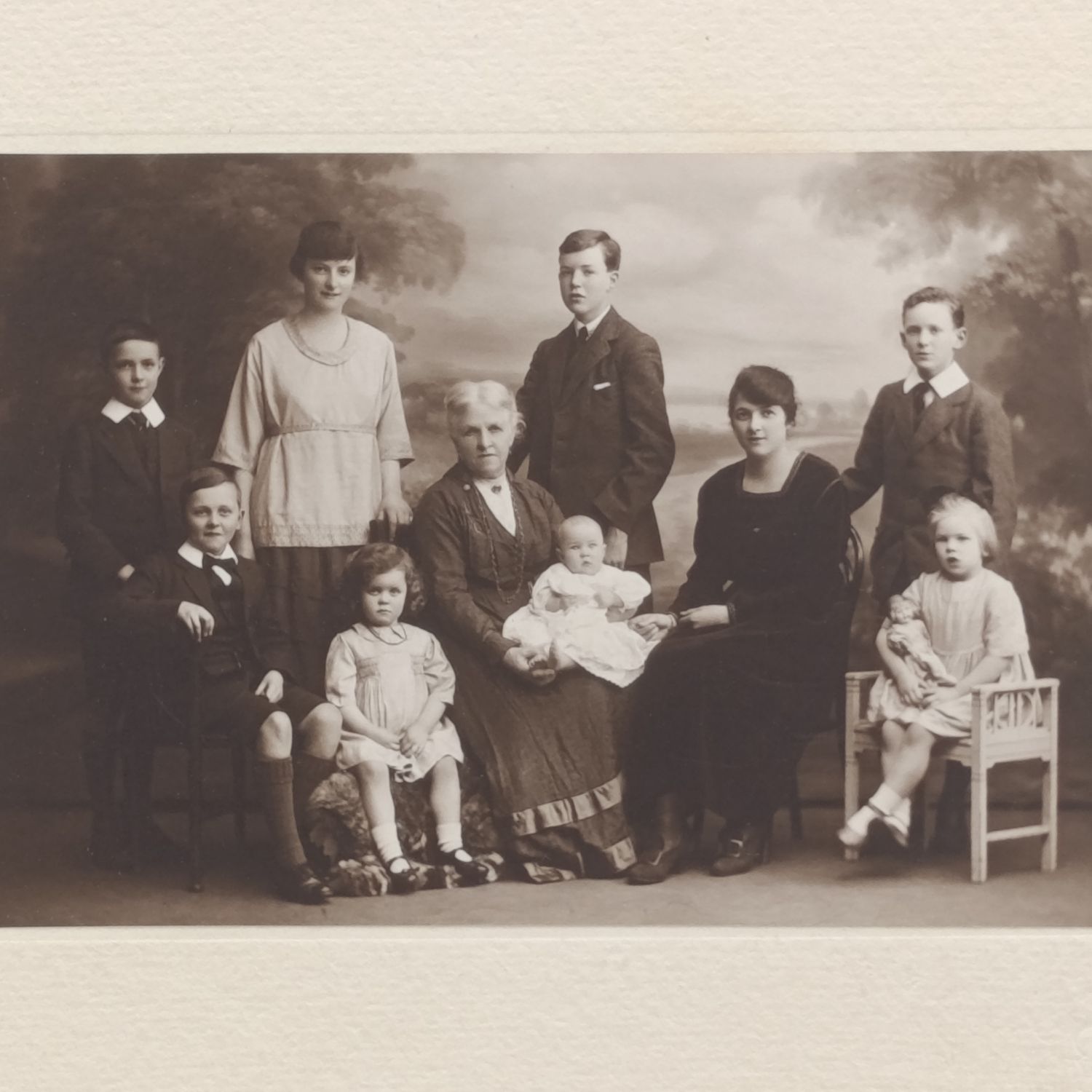 Antique Studio photo of Grandmother, mother and 8 children - note the doll set in Burnley area, England. 100mmx145mm